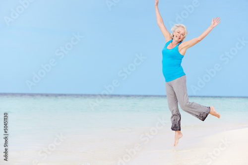 Photo: Senior Woman Jumping On Beautiful Beach Senior Woman Jumping On Beautiful Beach