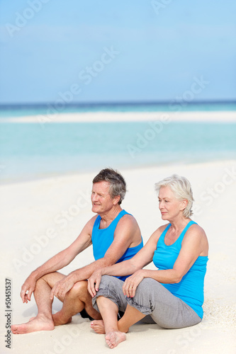 Photo: Senior Couple In Sports Clothing Relaxing On Beautiful Beach Senior Couple In Sports Clothing Relaxing On Beautiful Beach