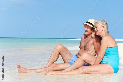 Photo: Senior Couple Enjoying Beach Holiday Senior Couple Enjoying Beach Holiday