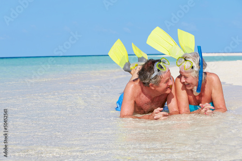 Photo: Senior Couple With Snorkels Enjoying Beach Holiday Senior Couple With Snorkels Enjoying Beach Holiday