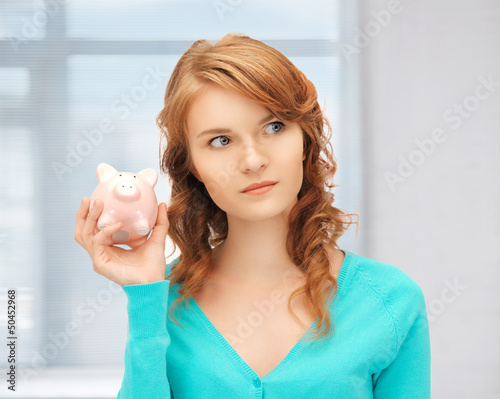 Photo: teenage girl with piggy bank teenage girl with piggy bank