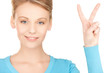 young woman showing victory or peace sign