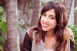 Photo: Portrait of a brunette woman smiling outdoors Portrait of a brunette woman smiling outdoors