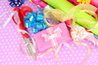 Rolls of Christmas wrapping paper with ribbons, bows
