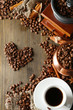 Cup of coffee, pot and grinder on wooden background