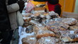 People buy flour products sugary cakes bread outdoor market fair