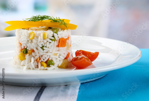 Photo: Delicious risotto with vegetables on table in cafe Delicious risotto with vegetables on table in cafe