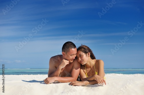 Photo: happy young couple enjoying summer on beach happy young couple enjoying summer on beach