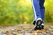 Photo: Woman walking cross country trail in autumn forest Woman walking cross country trail in autumn forest