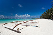 Wooden boat on tropical beach with white sand