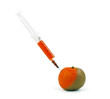 Partially colored tangerine with syringe
