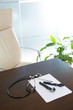 Photo : Doctor office table desk with stethoscope and otoscope Doctor office table desk with stethoscope and otoscope