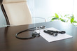 Photo : Doctor office table desk with stethoscope and otoscope Doctor office table desk with stethoscope and otoscope