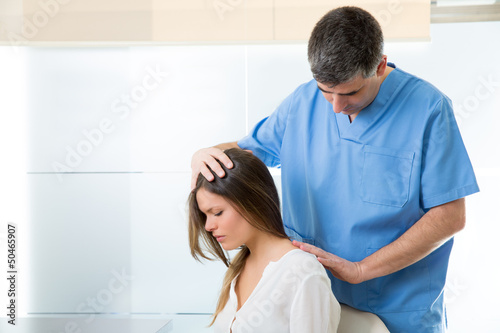 Photo: physiotherapist doing myofascial therapy on woman patient physiotherapist doing myofascial therapy on woman patient
