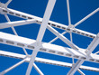 Steel beams against the blue sky. Fragment construction site.