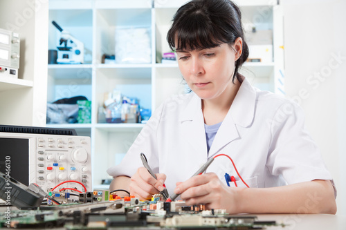 Photo: Girl debugging an electronic precision device Girl debugging an electronic precision device