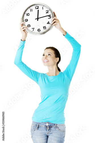 Photo: Happy young woman holding office clock Happy young woman holding office clock