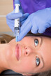 Foto: Anti aging facial mesotherapy syringe on woman face Anti aging facial mesotherapy syringe on woman face