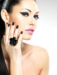 Face of the beautiful woman with black nails and pink lips