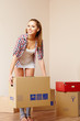 Photo: Young beautiful woman with packages for house moving Young beautiful woman with packages for house moving