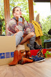 Photo: Young beautiful woman with packages for house moving Young beautiful woman with packages for house moving