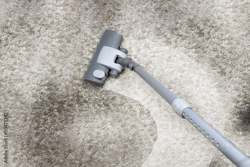 Photo: Vacuuming the carpet Vacuuming the carpet