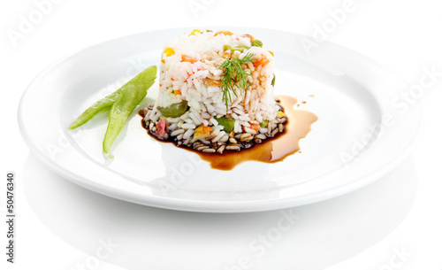 Photo: Delicious risotto with vegetables, isolated on white Delicious risotto with vegetables, isolated on white