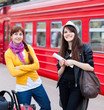 Two women are near the train