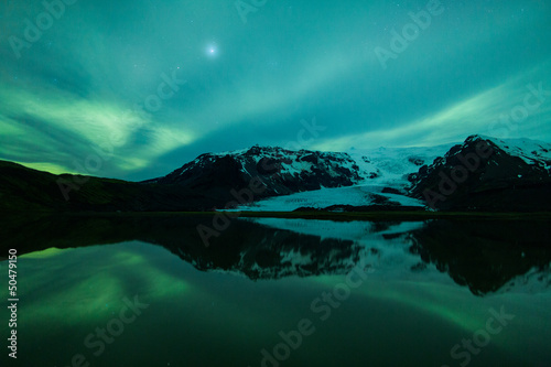 Photo: Northern lights above lagoon in Iceland Northern lights above lagoon in Iceland