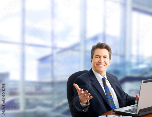 Photo: Businessman with laptop computer. Businessman with laptop computer.