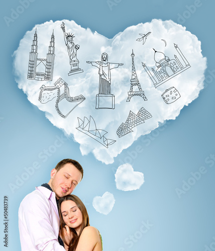 Photo: Young beautiful couple dreaming about their vacation. Famous tou Young beautiful couple dreaming about their vacation. Famous tou