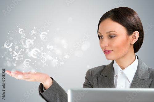 Photo: Investment concept. Pretty business woman with currency symbols. Investment concept. Pretty business woman with currency symbols.