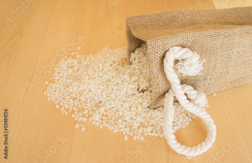 Photo: Pile of rice beans with wooden background Pile of rice beans with wooden background