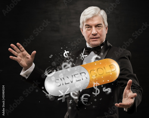 Photo: Investment concept. Handsome business man with currency symbols. Investment concept. Handsome business man with currency symbols.