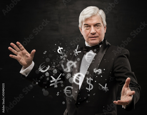 Photo: Investment concept. Handsome business man with currency symbols. Investment concept. Handsome business man with currency symbols.