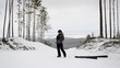 Skier photographs in the winter woods on a mountain top
