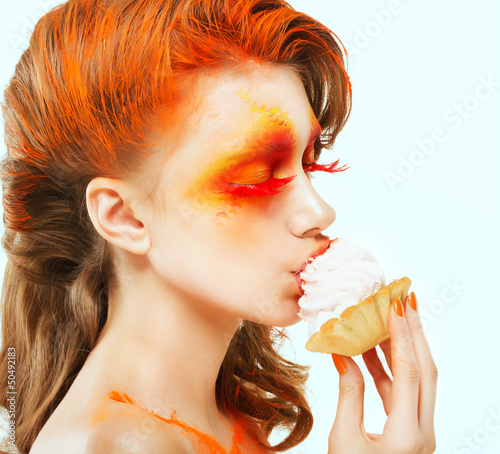 Photo: Coloring. Creativity. Red-haired Woman eating Cake with Cream Coloring. Creativity. Red-haired Woman eating Cake with Cream