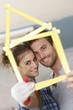 Happy couple smiling happy through little house