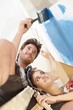 Happy couple painting wall