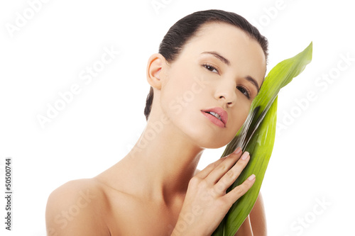 Photo: Beautiful woman with green exotic leaf Beautiful woman with green exotic leaf