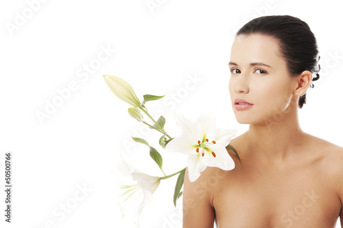 Photo: Young woman with health skin and with lily flower Young woman with health skin and with lily flower