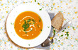 Carrot soup with cream and parsley, bread slice