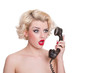 Shocked blond beauty on vintage telephone  - isolated on white