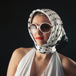 Retro woman with sunglasses fashion portrait against black