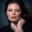 Sensual red head woman close up portrait on dark background.
