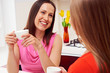 Photo: girls drinking coffee and speaking girls drinking coffee and speaking