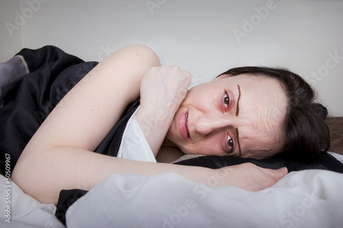 Photo: woman crying in bed woman crying in bed