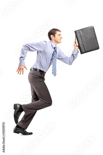 Photo: Full length portrait of a businessman running with a briefcase Full length portrait of a businessman running with a briefcase