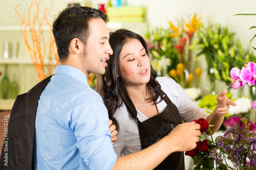 Photo: Saleswoman and customer in flower shop Saleswoman and customer in flower shop