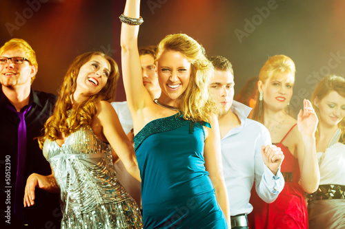 Photo: party people dancing in disco club party people dancing in disco club